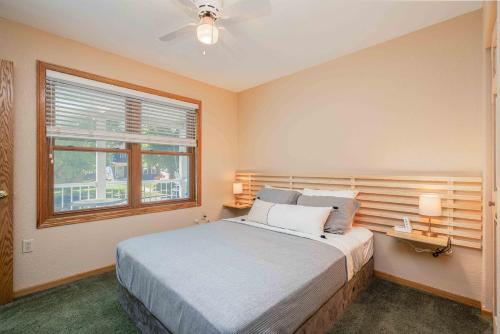 a bedroom with a large bed and a window at Grand Palace in Sioux Falls
