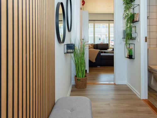 a living room with a chair and a mirror at 4 person holiday home in Ringkøbing-By Traum in Ringkøbing