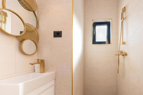 a bathroom with a sink and a mirror at Beach Haven house with pool and Jacuzzi in Kaštela