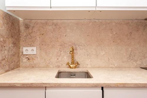 a kitchen counter with a sink and a window at Historic Center romantic apartment in Lisbon