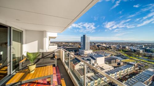 a balcony with a view of a city at CBD Loft Style Apartment with Free Valet Parking in Christchurch