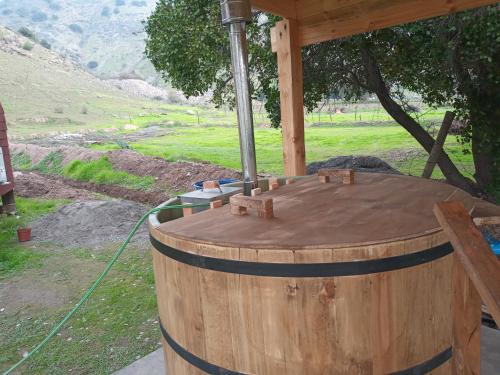 a large wooden barrel sitting under a roof at Domo, Cabaña, El Rulo Coinco in Rancagua