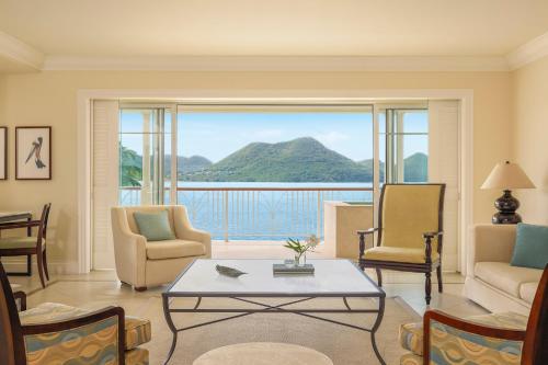 a living room with a view of the ocean at The Landings Resort and Spa - All Suites in Gros Islet