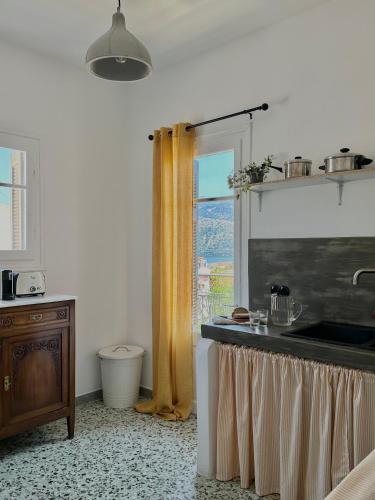 a kitchen with a sink and a window at The Lassis 15 House in Argostoli
