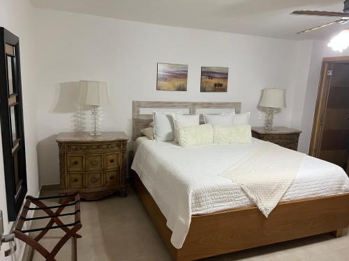 a bedroom with a large bed and two night stands at Marbella Towers - Ocean Front in Juan Pedro