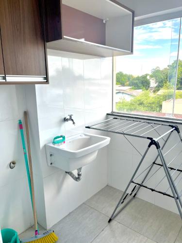 a bathroom with a sink and a window at Residencial renaissance in Boa Vista