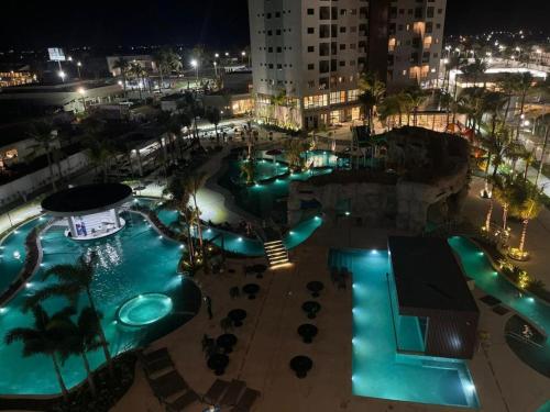 a swimming pool at night with blue lights at SALINAS PREMIUM RESORT in Salinópolis