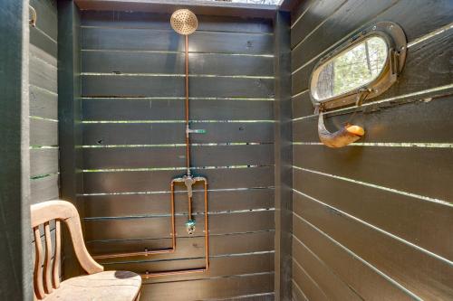 a shower in a room with a wooden wall at Charming Eclectic Vacation Rental with Beach Access! in Eclectic