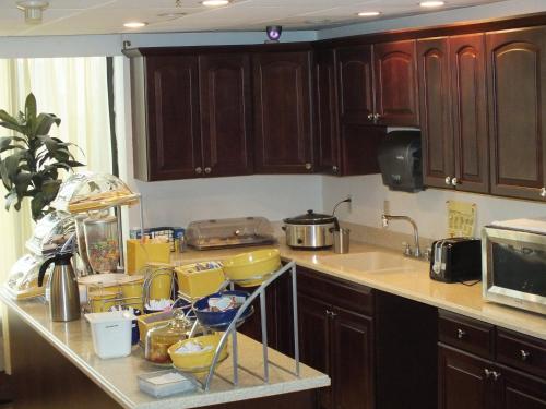 a kitchen counter with a bunch of dishes on it at Days Inn by Wyndham Indianapolis Northeast in Indianapolis