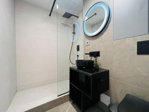 a bathroom with a sink and a mirror on the wall at Impact Apartments in Piteşti