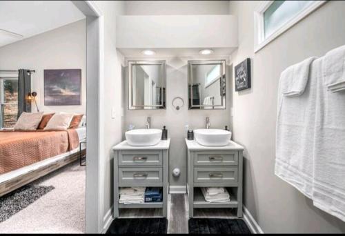 a bathroom with two sinks and a bed at Beautiful home in Rocky Mount