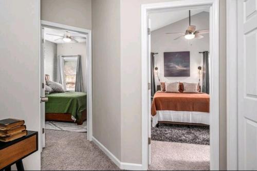 a room with a bedroom with two beds and a ceiling fan at Beautiful home in Rocky Mount