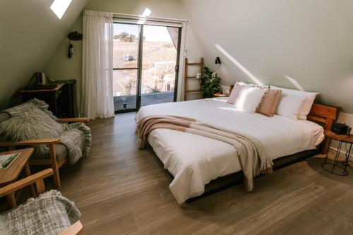 a bedroom with a large bed and a window at The Cove Tasmania in Devonport