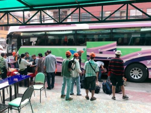 a group of people standing in front of a bus at Vientiane Memory Hotel in Vientiane