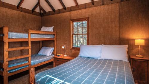 a bedroom with two bunk beds and a ladder at Brickendon in Longford