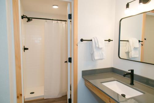 a bathroom with a sink and a mirror at LOGE Wolf Creek in South Fork