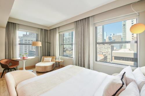 a hotel room with a bed and a large window at Virgin Hotels Chicago in Chicago