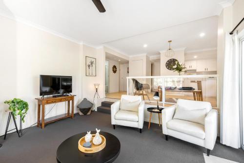 a living room with two chairs and a table at Enjoy 15 percent off stays in February and March, discount already applied to the nightly rate. Book now. in Mollymook