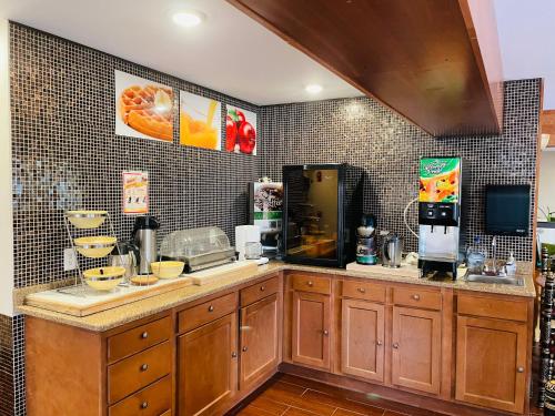 a kitchen with a counter with a coffee maker at Super 8 by Wyndham Gloucester in Gloucester City