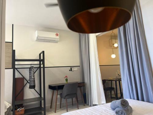 a bedroom with a bed and a dining room with a table at Topaz Nilam Residence 5 pax The Shore KK Centre in Kota Kinabalu