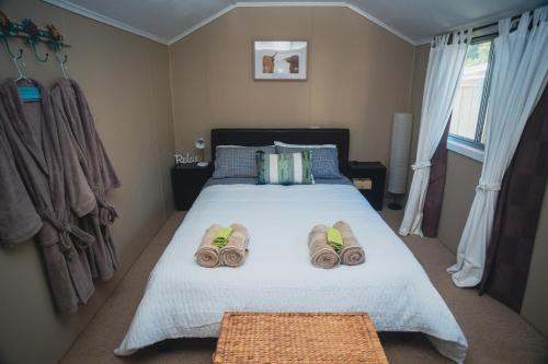 a bedroom with a bed with towels on it at Kooringa Cottage in Burra
