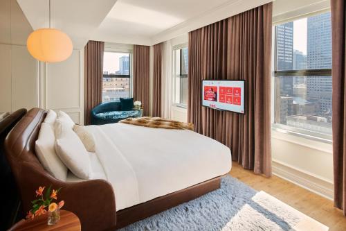 a bedroom with a large bed and a large window at Virgin Hotels Chicago in Chicago