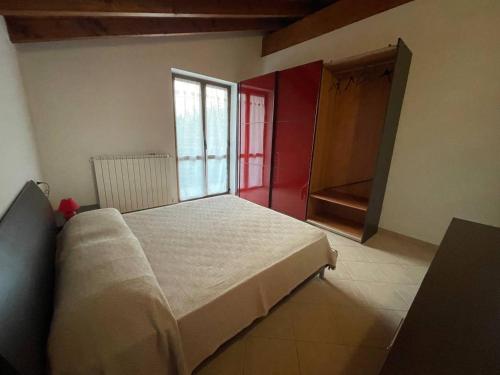 a bedroom with a white bed and a window at Villetta 2 piani in Borgo Ticino