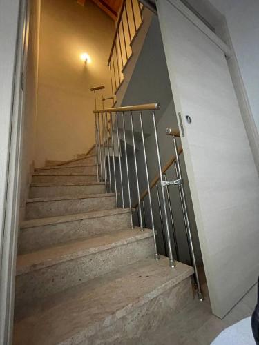 a set of stairs in a building with a stair railing at Villetta 2 piani in Borgo Ticino