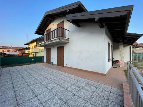 a white house with a balcony and a patio at Villetta 2 piani in Borgo Ticino