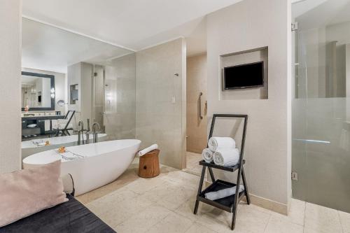 a large bathroom with a tub and a tv at Live Aqua Ciudad de Mexico Bosques de las Lomas in Mexico City