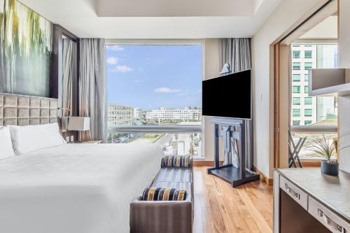 a hotel room with a bed and a large window at Live Aqua Ciudad de Mexico Bosques de las Lomas in Mexico City