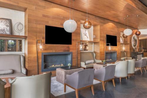 a living room with a fireplace and a bunch of chairs at Live Aqua Ciudad de Mexico Bosques de las Lomas in Mexico City