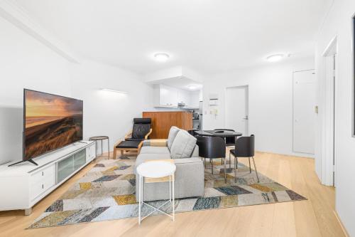 a living room with a couch and a table at Cleveland 49 Self Catering in Sydney