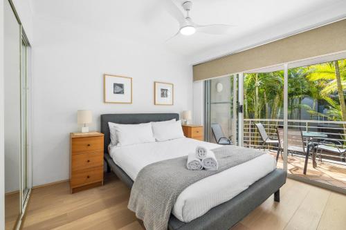 a bedroom with a large bed and a balcony at Cleveland 49 Self Catering in Sydney