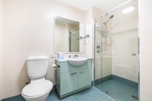 a bathroom with a toilet and a sink and a shower at Cleveland 49 Self Catering in Sydney