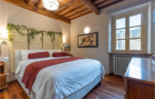 a bedroom with a large bed and a window at Stunning Home In Capannori With Jacuzzi in Capannori
