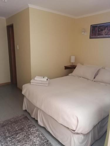 a bedroom with a large white bed in a room at Hostal Solor in San Pedro de Atacama