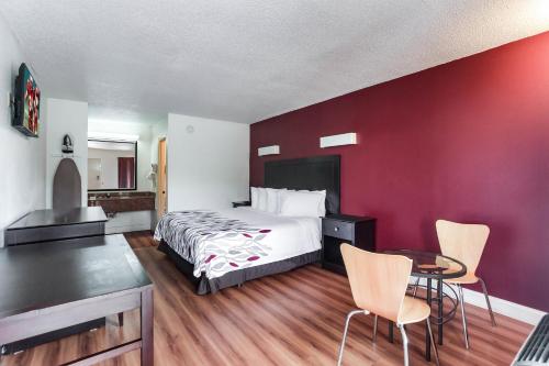 a hotel room with a bed and a table and chairs at Red Roof Inn Monteagle - I-24 in Monteagle
