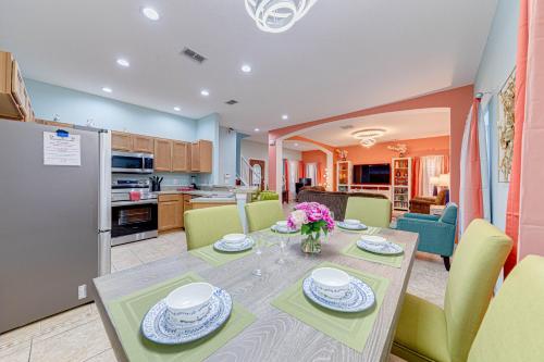 a kitchen and dining room with a table and chairs at Affordable 4 Br Luxury Villa near Disney/Private Pool/Arcade/Game room in Orlando