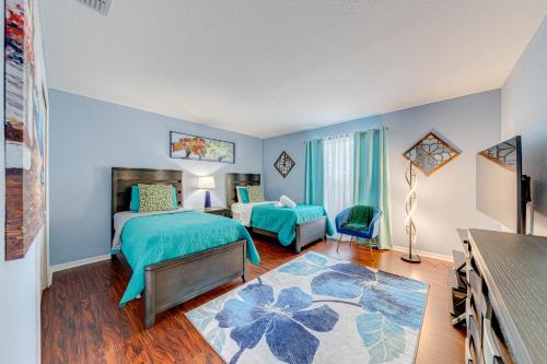 a bedroom with two beds with blue walls at Affordable 4 Br Luxury Villa near Disney/Private Pool/Arcade/Game room in Orlando