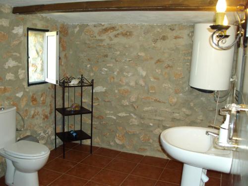 a bathroom with a toilet and a sink at House No 02 median in Humilladero