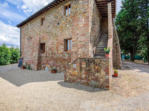 a brick building with a staircase on the side of it at Idyllic Farmhouse in Gambassi Terme Fi with Swimming Pool in Querce