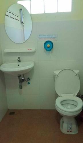 a bathroom with a toilet and a sink and a mirror at Najjamee Bungalows in Ko Yao Noi
