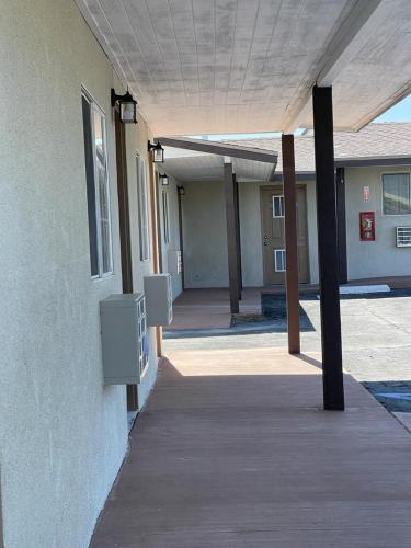 an empty hallway of a building next to a building at Palm Inn in Mojave