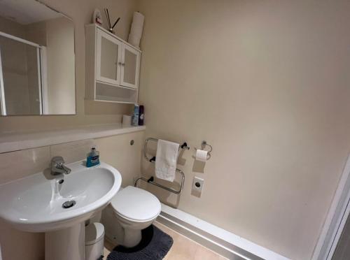a white bathroom with a sink and a toilet at Aberdeen stay central 2-bedrooms apartment in Aberdeen