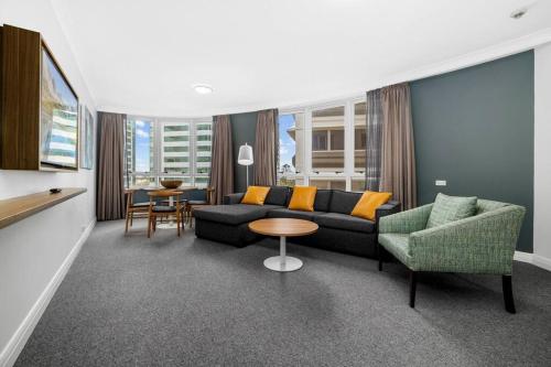 a living room with a couch and chairs and a table at Chatswood Hub Self- Catering 815 in Sydney