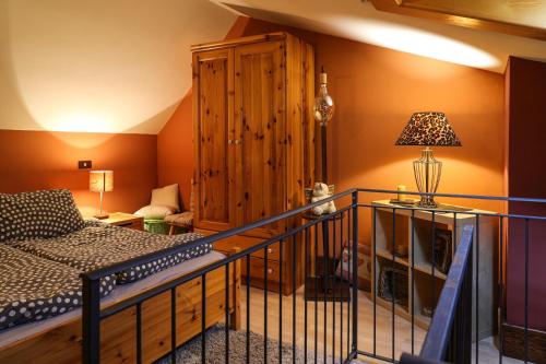 a room with a staircase with a bed and a lamp at Il Nido in Sestola