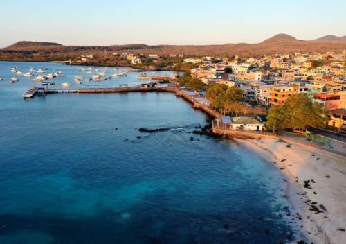 an aerial view of a beach with boats in the water at Moonlight, Galápagos in San Cristobal