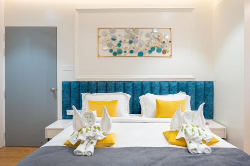a bedroom with a bed with two white and yellow pillows at Clubway Grand A Boutique Hotel in Jorhāt