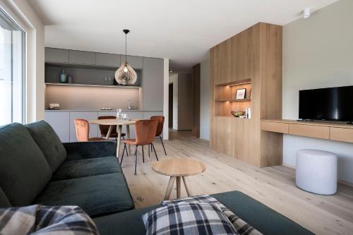 a living room with a couch and a table at Astor Apartments in Valdaora